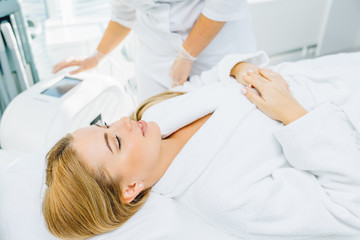 Obraz na płótnie Canvas Gorgeous woman in beauty clinic receiving non-surgical face lifting. SMAS lifting ultrasonic. Facelift. The process of rejuvenation. Spa treatment. Hardware cosmetology.