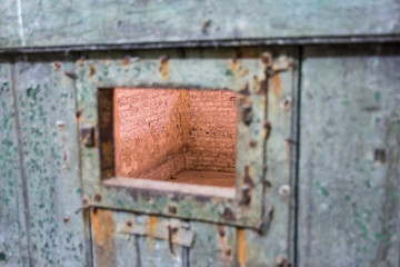 view through prison cell door window abstract photo