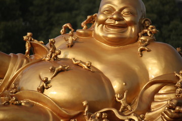Golden buddha image in a temple and place of worship in old town Shanghai, China, Asia