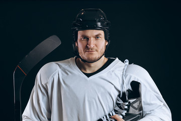 Naklejka premium Emotional hockey player looking at camera skate and gaming stick . Isolated on black