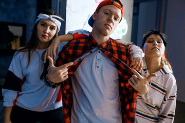 cool teen's group leaded by a gorgeous guy. close up photo. fashion , style concept