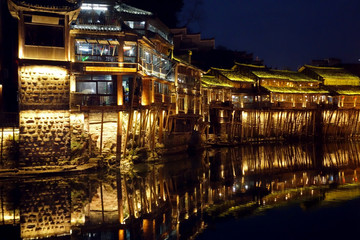 Fototapeta na wymiar Night light scenery of Fenghuang ancient city in Xiangxi, Hunan province, China. Most famous ancient town in China. Selective, soft focus.
