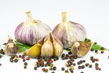 A garlic heads, parsley leaves, colorful allspice isolated on a white background.