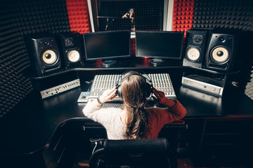 young DJ regulating the music. close up back view photo. musica fan . making a song