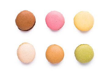 Assortment of macarons isolated over white background, top view