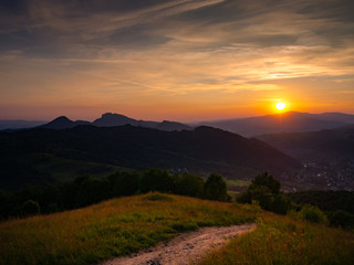 Fototapeta na wymiar Sunset over Gorce Mountains, Luban Mount. Mount Palenica and Trzy Korony Massif on left side. Town Szczawnica in Valley. View from Mount Jarmuta, Pieniny, Poland.