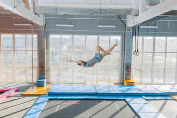 dangerous jumping at fitness center. side view full length shot. man falling on the floor