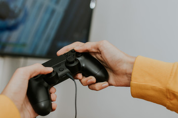 hand with the joystick playing video games