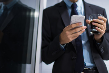 business man with mobile phone and coffee mug