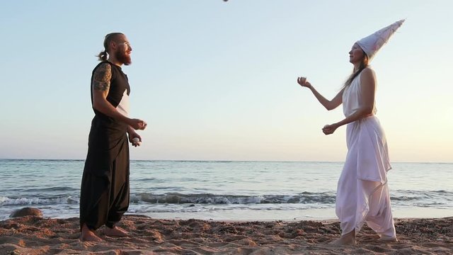 Amazing juggling performance at ocean beach at sunset shaky footage slow motion