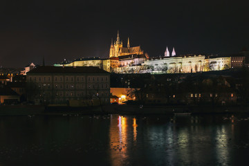 Fototapeta na wymiar The Metropolitan Cathedral of Saints Vitus at night from Charles Bridge in Prague, Czech Republic