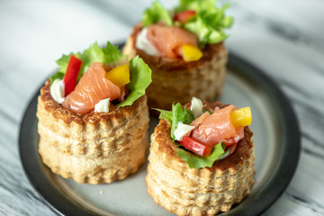 French cuisine, crunchy patties with lettuce and smoked salmon on a bright, rustic background
