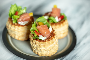 French cuisine, crunchy patties with lettuce and smoked salmon on a bright, rustic background