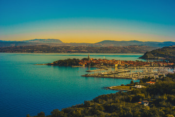 Fototapeta na wymiar Aerial view of old fishing town Izola. Colorful spring evening on Adriatic Sea. Beautiful seascape of Slovenia, Europe. Beauty of countryside concept background. Artistic style post processed photo.