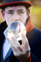 handsome businessman looking at a glass sphere