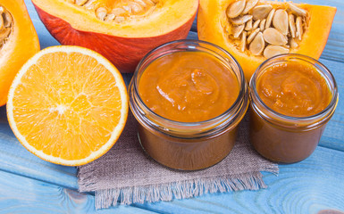 Homemade preserves. Pumpkin jam on a wooden background.