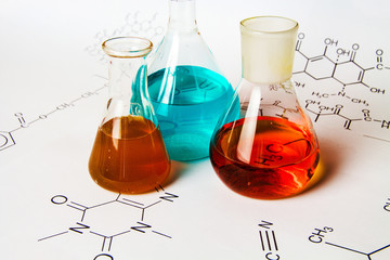 Chemical tube with reaction formula background. Special toning