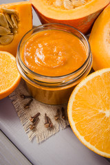 Homemade preserves. Pumpkin jam on a wooden background.