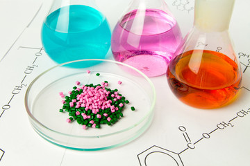 Plastic raw material in granules against the background of Chemical Laboratory and reagents. Polypropylene, Ethylene, Polypropylene research in laboratory conditions