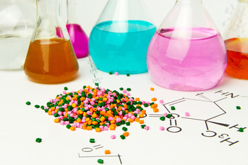 Plastic raw material in granules against the background of Chemical Laboratory and reagents....