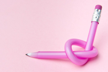 Flexible pencil on pink background. Bent pencils. Flexible business concept.