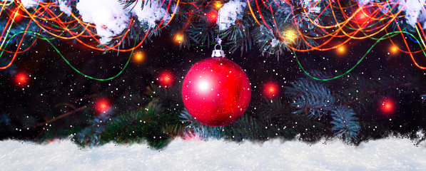 Red Ball Hanging At Fir Branches with snow, snowflakes and lanterns, festive greeting card...