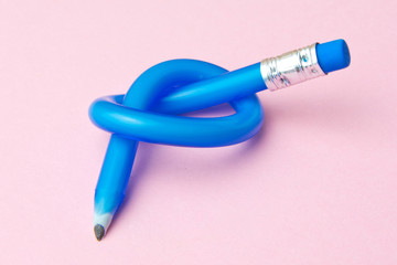 Flexible pencil on pink background. Bent pencils. Flexible business concept.