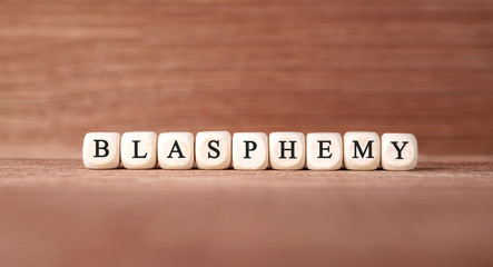 Word BLASPHEMY made with wood building blocks