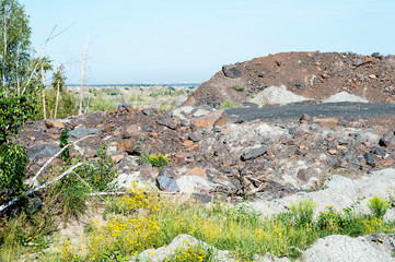 Fototapeta na wymiar Desert landscape after mining activities. The destruction of forests due to the overburden dump pit