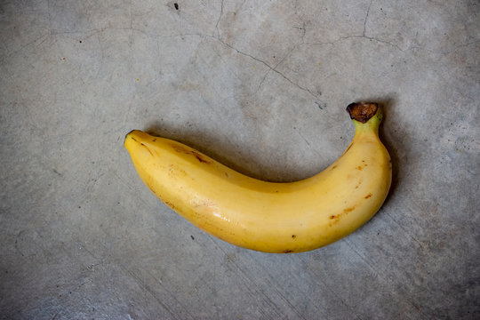 Banana on the cement floor. The food isolated photo.
