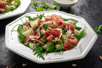 Parma ham and melon salad with mozzarella, rocket and pine nuts