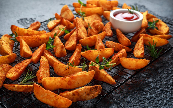 Paprika potato wedges fries chips, with ketchup and thyme