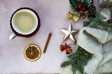 Golden stars, gift box, cup of coffee, christmas tree branch and decorations on light pink textured background. Christmas, new year, winter concept. Flat lay, top view, copy space