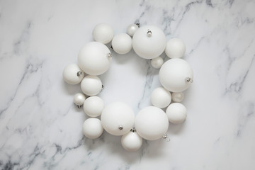 Christmas composition. white festive ball decorations on a marble background