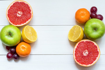 Citrus fruits on the white wooden table, copy space