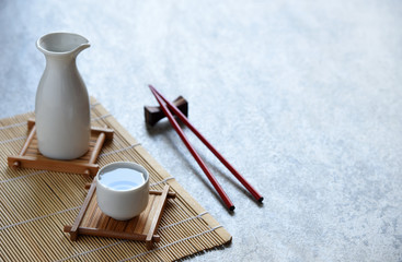 Obraz na płótnie Canvas japanese sake set oriental drink style and chopsticks on the table