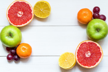 Citrus fruits on the white wooden table, copy space