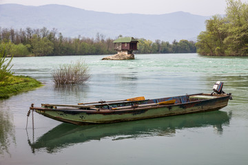 Lonely house and small boat on the river Drina, Serbia