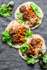 Meatballs, spicy stewed chickpeas and cabbage slaw tortilla -  delicious snack, brunch, appetizers, tapas on a gray background, top view. Flat lay, copy space