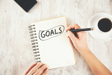 woman hand goals text on notepad