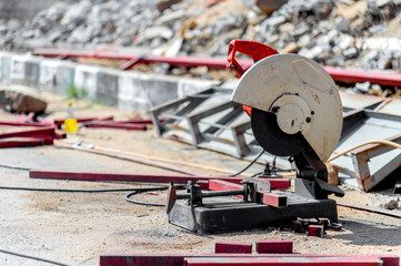 closeup steel cut machine with soft-focus and over light in the background
