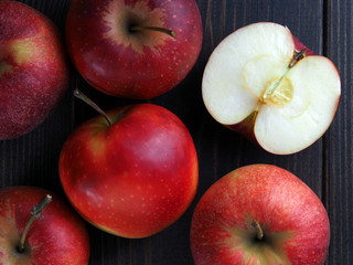 red apples on dark wooden table as background and texture