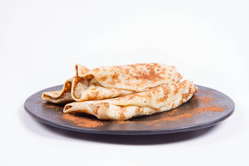 Pancakes stuffed with braised apples sprinkled with cinnamon