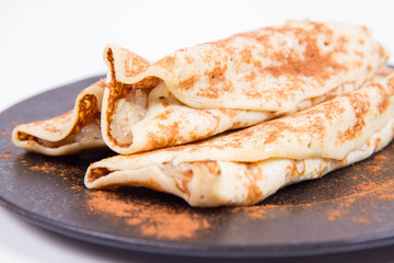 Pancakes stuffed with braised apples sprinkled with cinnamon