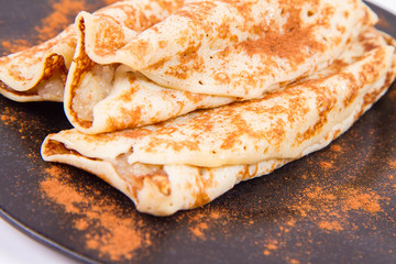 Pancakes stuffed with braised apples sprinkled with cinnamon