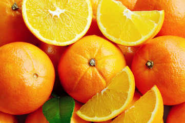 Obraz na płótnie Canvas A lot of An orange, whole and split. Sweet orange is the fruit of the citrus.