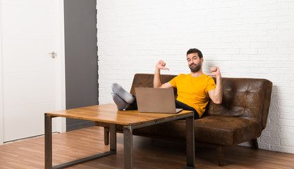 Man with his laptop in a room proud and self-satisfied in love yourself concept