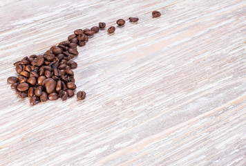 coffee beans on a light wooden table