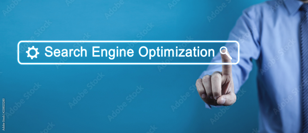 Wall mural hand touching on search engine optimization text.
