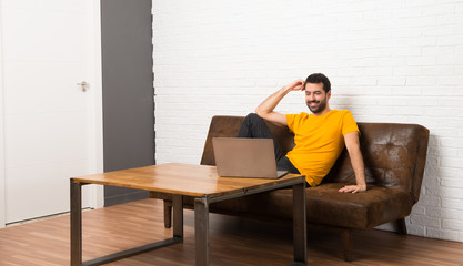 Man with his laptop in a room